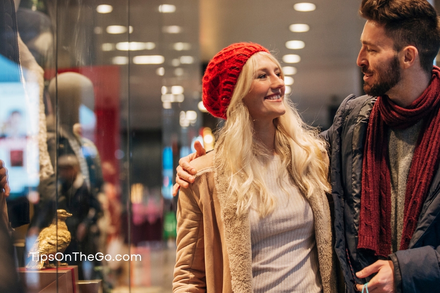 A sweet couple walking down the street and having a good time. 