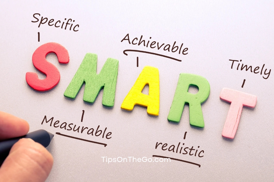 A hand writing the word smart on a white board.