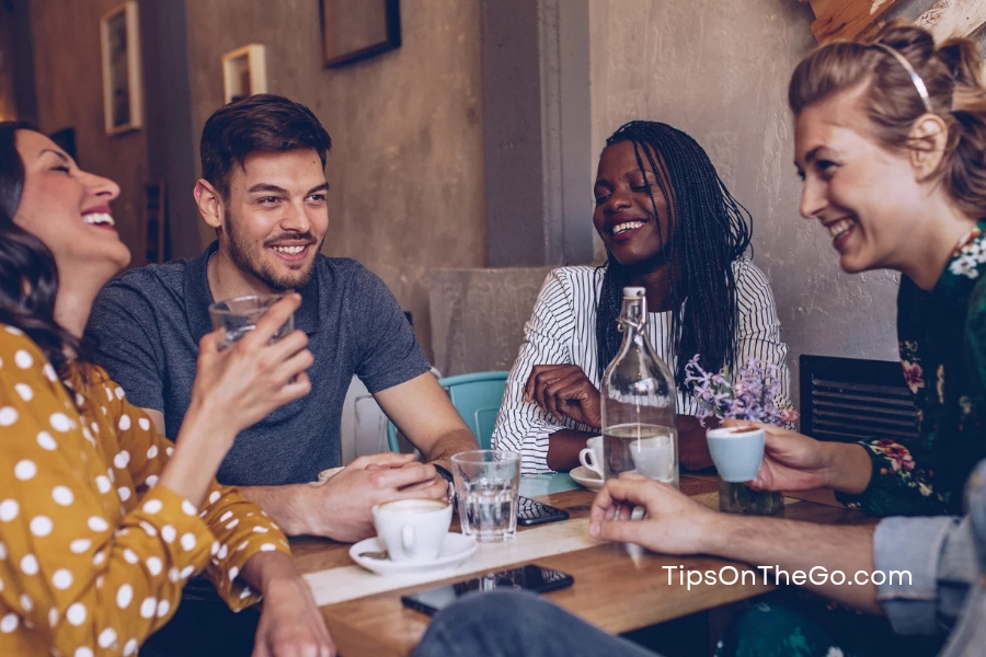 A group of friends having a conversation in a restaurant.