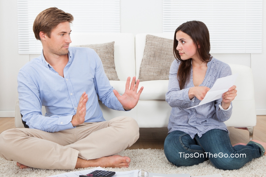 Two people sitting on the floor in the living room