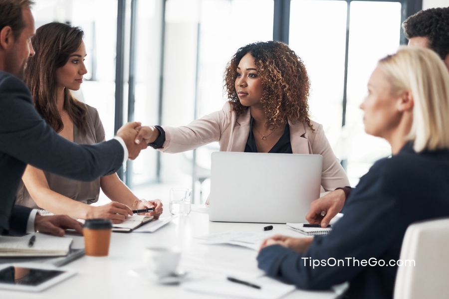 A group of business people shaking hands at a meeting